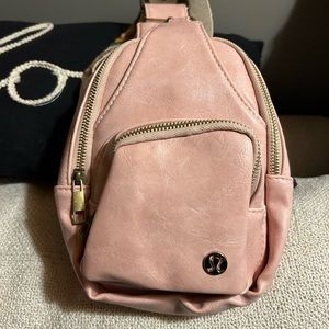 Pink lululemon backpack. Small in make but fits cards ,and phone plus makeup